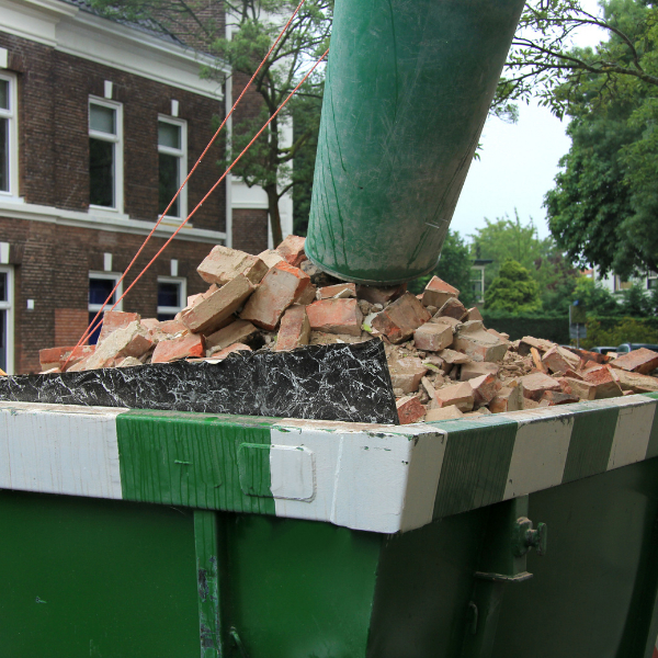 Dumpster Rental Woodstock GA - Common Mistakes You Should Avoid When Renting a Dumpster - a green dumpster full of construction debris