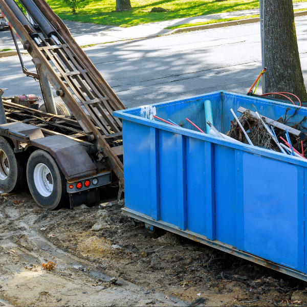 The Ultimate Collection of FAQs about Roll-Off Dumpsters in Woodstock, GA - a blue dumpster being delivered