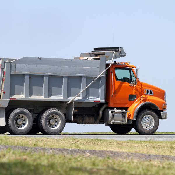 does dumpster rental include disposal - Dumpster vs. Dump Truck - Which One Should I Rent - an orange and gray dump truck