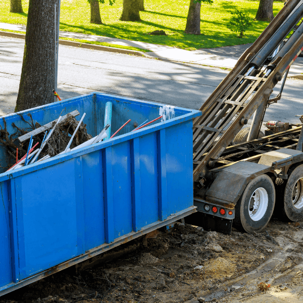 residential dumpster rental Canton GA - The Top 15 Reasons to Rent a Dumpster in Marrietta - blue dumpster getting ready to be hauled away