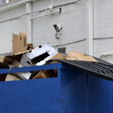 commercial dumpster rental marietta ga - Choosing a Dumpster Rental Company for Your Business - blue dumpster in the back of a commercial building
