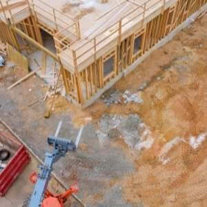 construction dumpster rental Roswell - Why a Dumpster Rental is the Right Choice for Your Roswell Home Remodeling Project - a red dumpster in the foreground of a new home construction