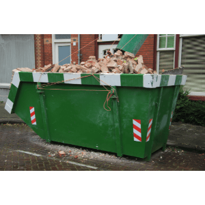 how much does a 10-yard dumpster rental cost - 10 Factors That Affect Dumpster Rental Rates - an open. green dumpster with concrete and rocks from a demolition