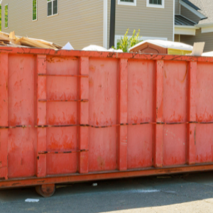 residential dumpster rental Woodstock - Residential Dumpsters 5 Things to Consider - an orange dumpster in front of a home